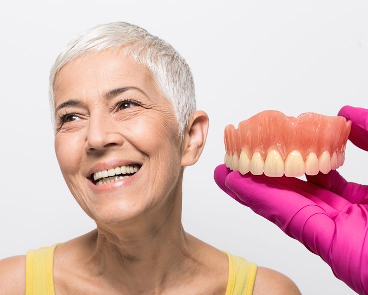 Patient viewing a full-mouth dental restoration