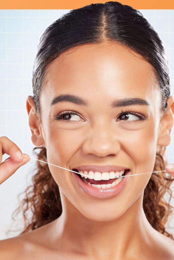 Patient protecting her restored smile with floss