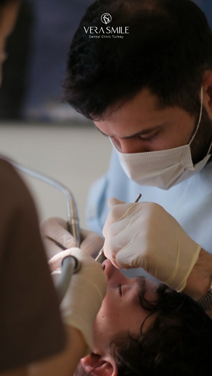 Dentist performing careful periodontal treatment
